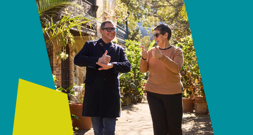 Image of two people communicating through sign language