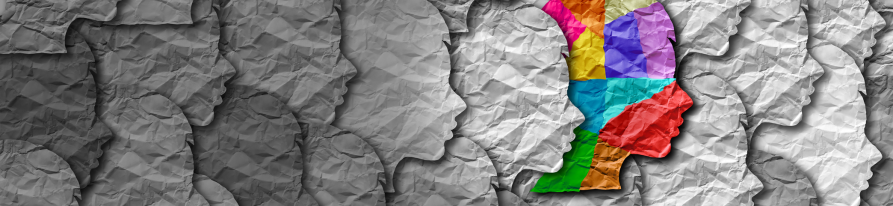 Conceptual image of paper heads facing right, one of the heads is multi-coloured