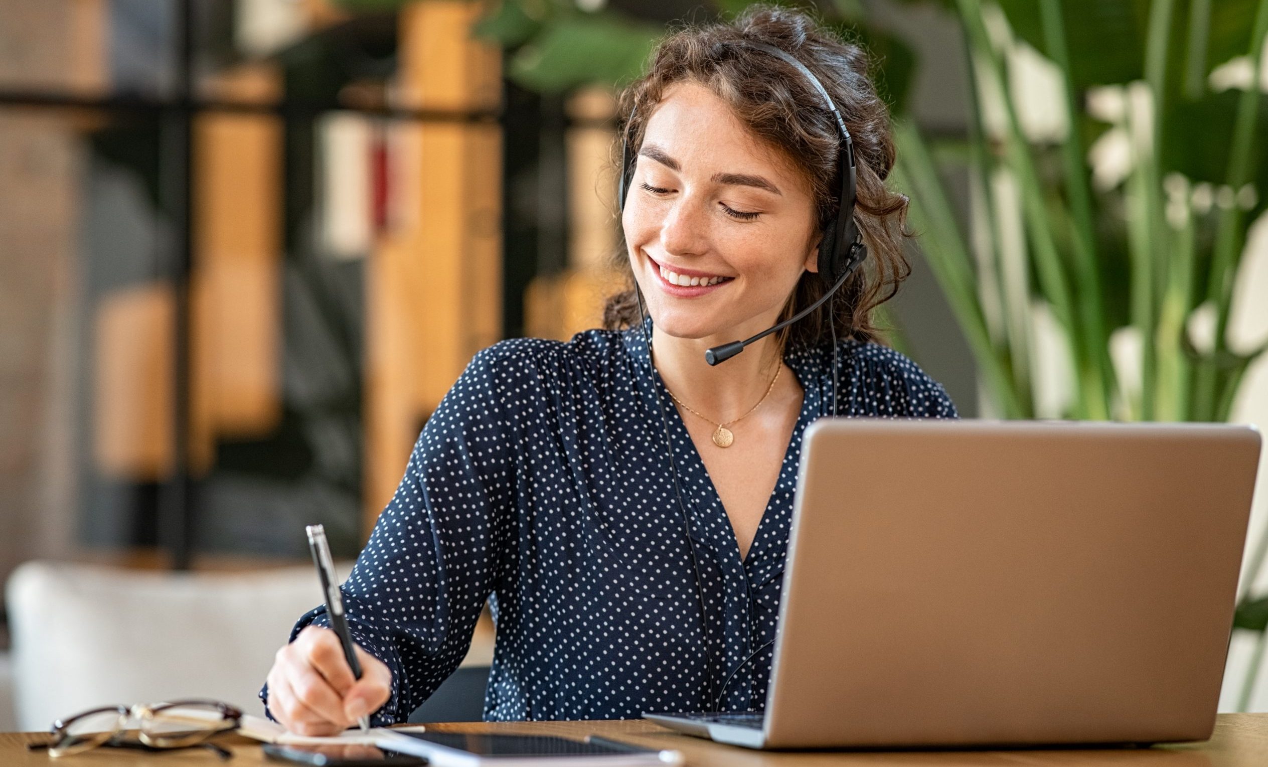 Successful customer service representative using laptop at office
