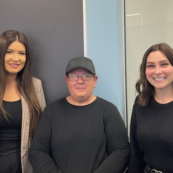 Client Bronwyn stands in the middle of atWork Australia team members Rachael and Ashleigh who are happy to have helped Brownyn find good work.