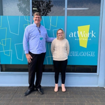 Shanae stands proudly with Job Coach outside of atWork Australia Office